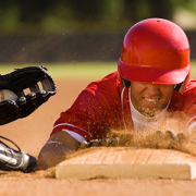 Baseball player sliding into base.