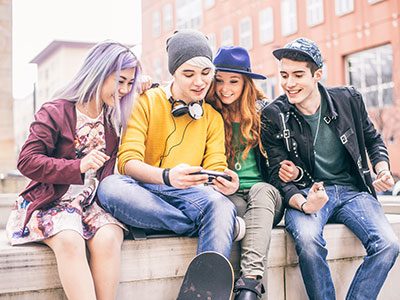 Group of teens looking at a phone