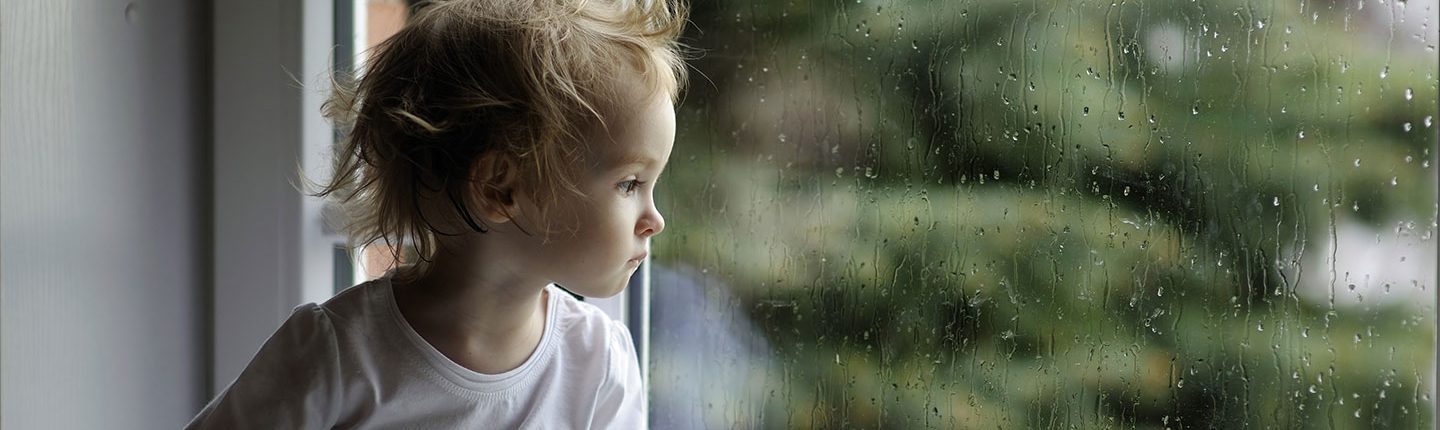 sad child in window