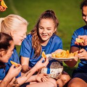 girls soccer team eating oranges