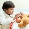 little boy listening to teddy bear's heart with stethoscope