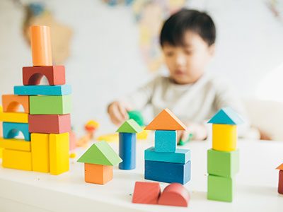 little boy playing with building block