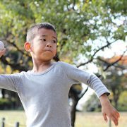 little boy throwing baseball