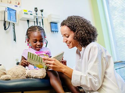 Dr. Marcee White examines a little girl