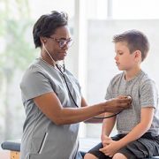 Nurse Checking a Child's Heartbeat