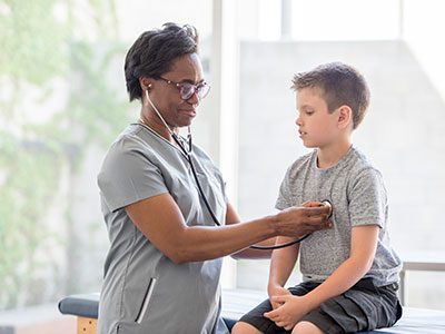 Nurse Checking a Child's Heartbeat