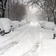 a road full of snow covered cars