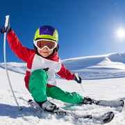 Little skier having fun at sunny snowy day