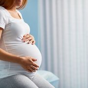 Pregnant woman holding her belly