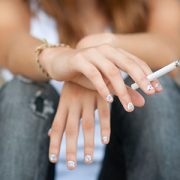 teeaged girl holding a cigarette
