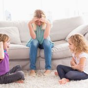 two girls arguing in front of mom