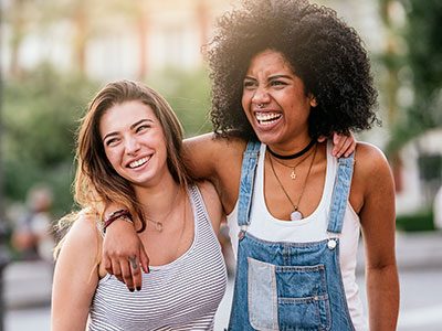 two teen girls smiling