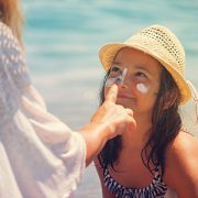 mother applying sunscreen to daughter's face