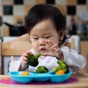 Baby girl eating vegetables