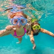 mother and daughter swimming underwater