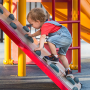 Little boy climing a playground structure-feature