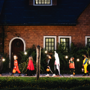 Group of kids with Halloween costumes walking to trick or treating