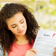 Student Holding Exam Result With F Grade
