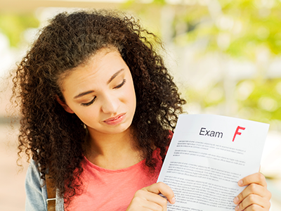 Student Holding Exam Result With F Grade