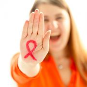 smiling woman with red AIDS ribbon drawn on hand