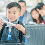 little boy holding toy airplane