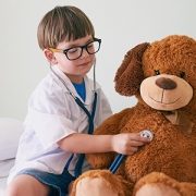 Little boy listenting to heartbeat of stuffed bear