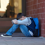 boy crying in front of school