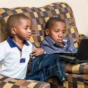 two boys looking at a computer screen