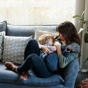 mom nursing toddler on couch
