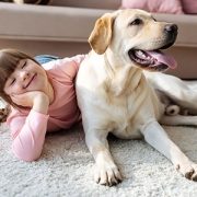 girl lying on the floor with her dog