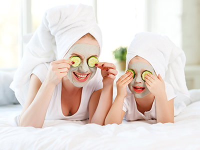 mother and daughter doing face masks
