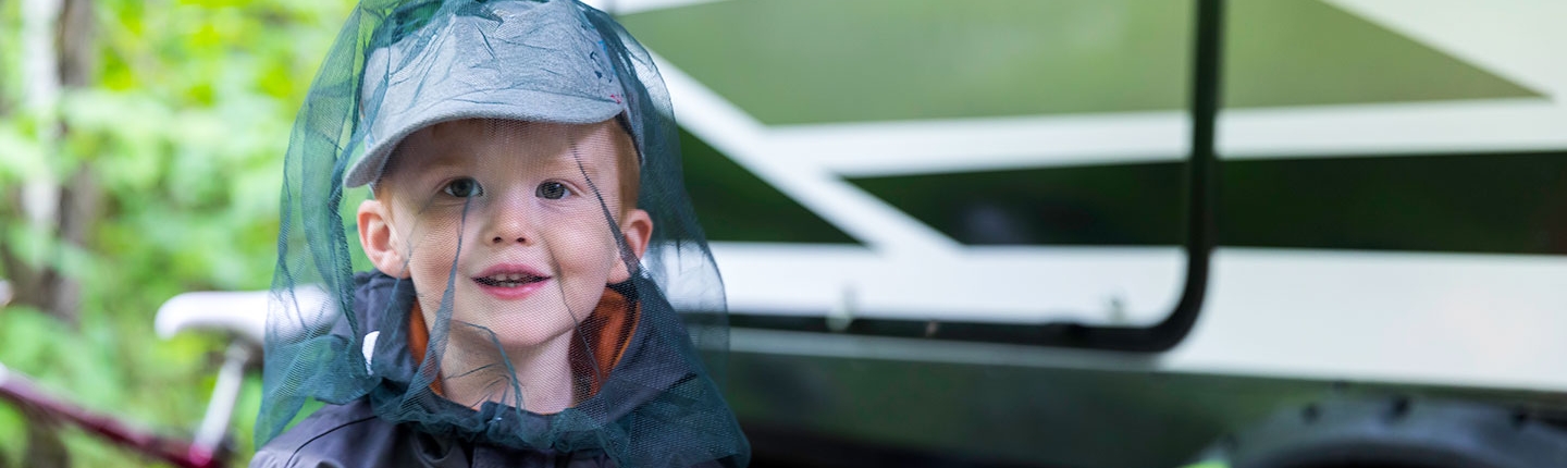 little boy with mosquito netting hat