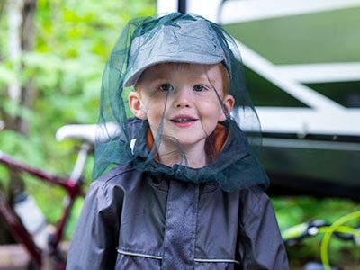 little boy with mosquito netting hat