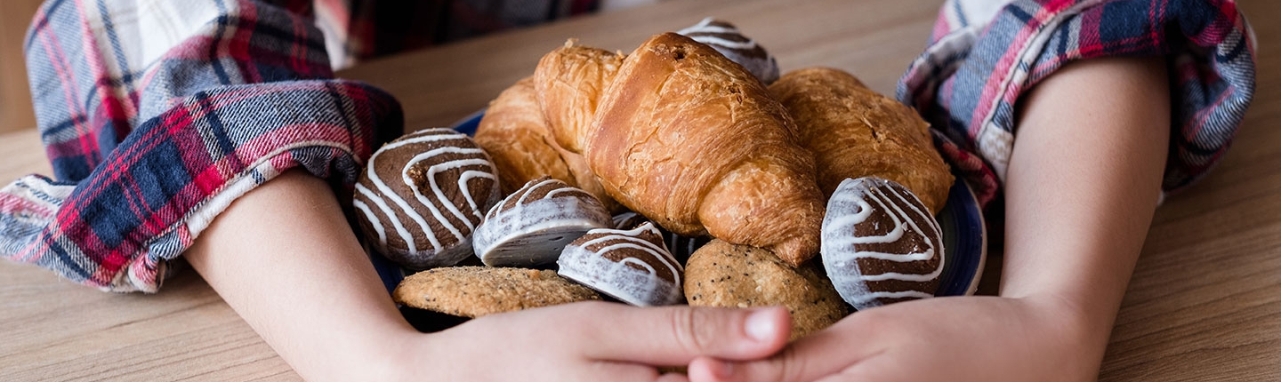 child hoarding cookies and croissants