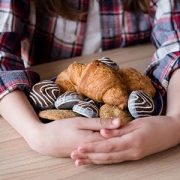child hoarding cookies and croissants