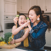 Mother and daughter laughing in kitchen