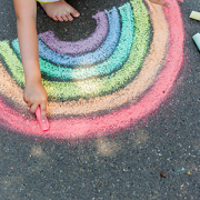 child drawing chalk rainbow