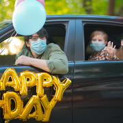 family celebrating birthday while social distancing in car