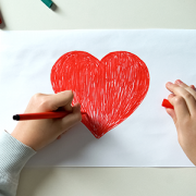 child drawing a heart