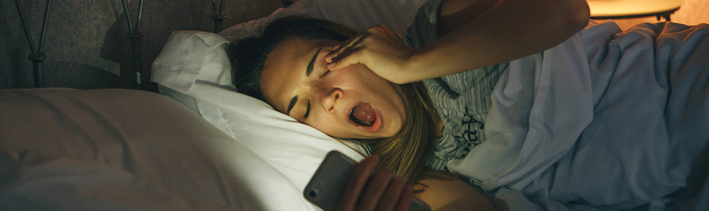 teen girl in bed yawning