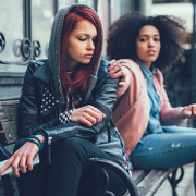 teen girls sitting on bench talking