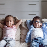 girl and boy relaxing on couch