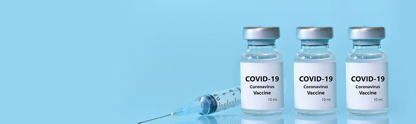 COVID-19 vaccine vials and needle
