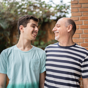 father and autistic son smiling