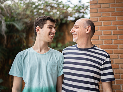 father and autistic son smiling