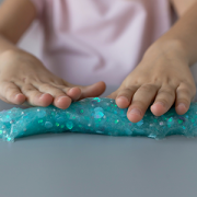 child playing with blue slime