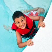 boy wearing a life jacket in swimming pool