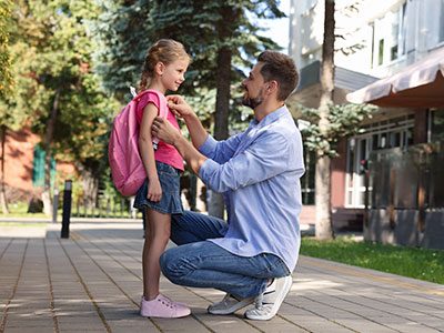 Father sending daughter off to school