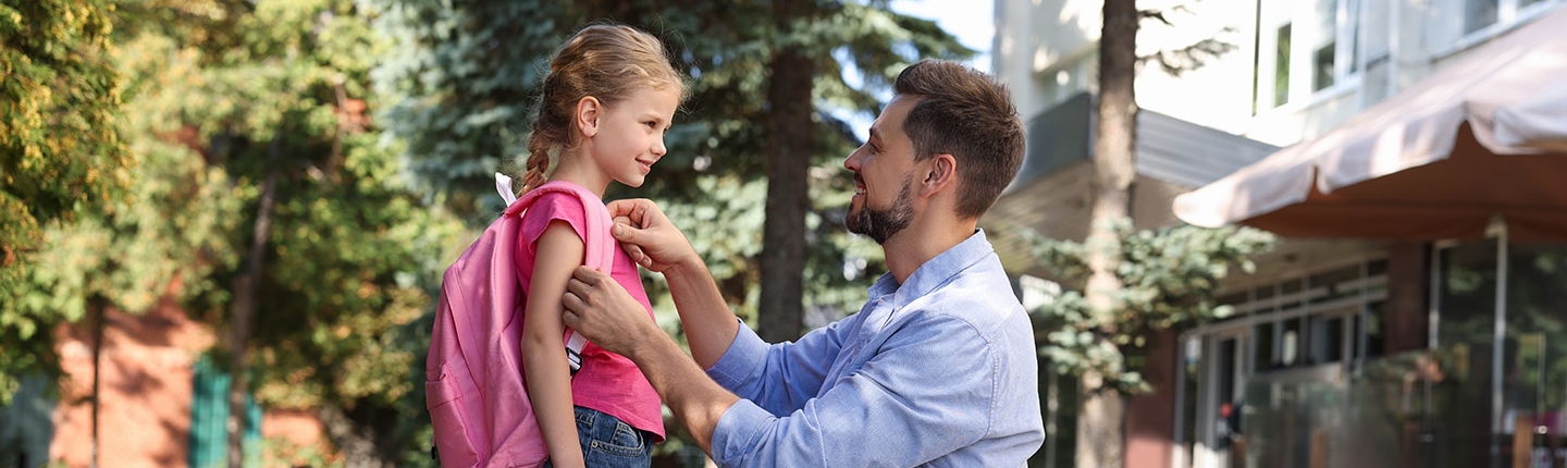 Father sending daughter off to school