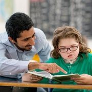 Teacher helping student in special education class